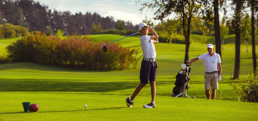 young golfer hitting off tee